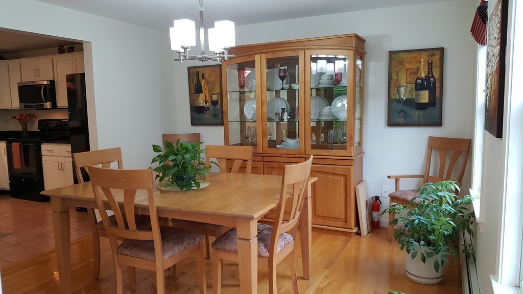 23 Calvin Street Ayer, MA 01432 - Photo 18 of 30 a dining room with furniture potted plants and wooden floor