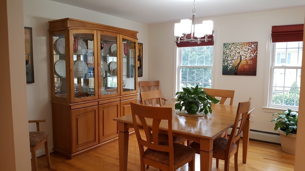 23 Calvin Street Ayer, MA 01432 - Photo 19 of 30 a dining room with furniture potted plants and wooden floor