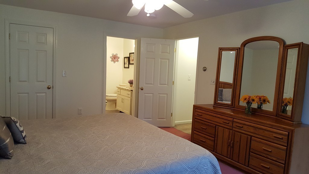 23 Calvin Street Ayer, MA 01432 - Photo 23 of 30 a bedroom with a bed and a dresser with mirror
