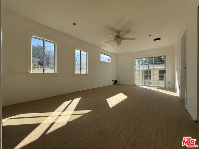 a view of livingroom with hardwood floor and a ceiling fan