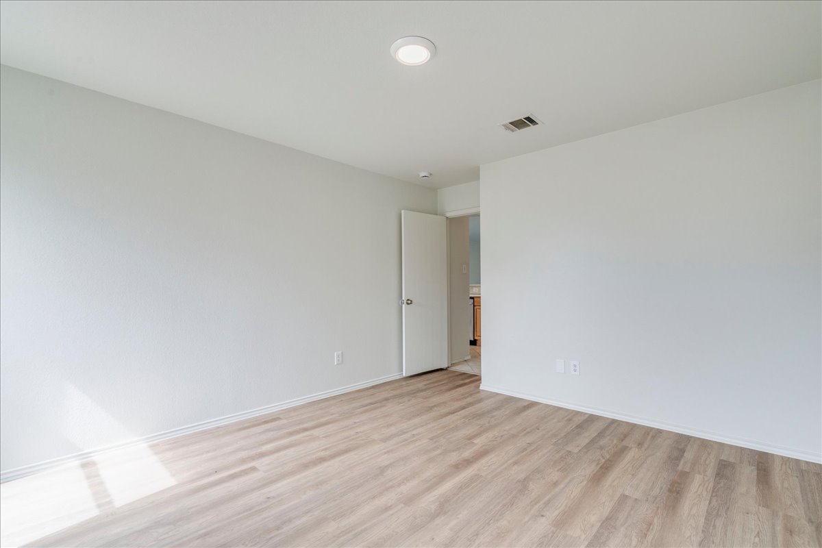 100 Easy Street Hutto, TX 78634 - Photo 14 of 36 A well-lit room offers contemporary flooring and clear walls for personalized decor.