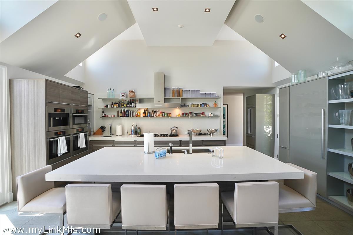 30 Crackatuxet Road Edgartown, MA 02539 - Photo 12 of 45 a kitchen with a table chairs and stove