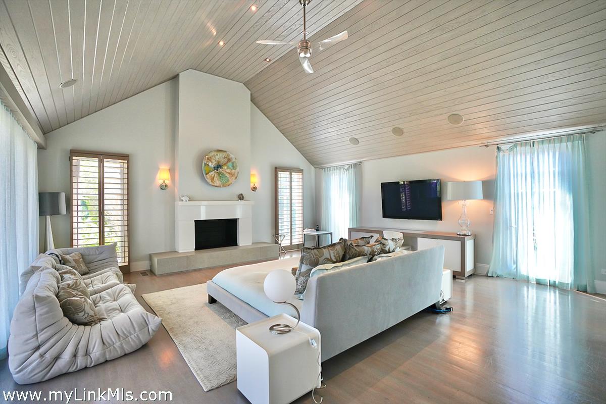 30 Crackatuxet Road Edgartown, MA 02539 - Photo 14 of 45 a living room with furniture a fireplace and a flat screen tv