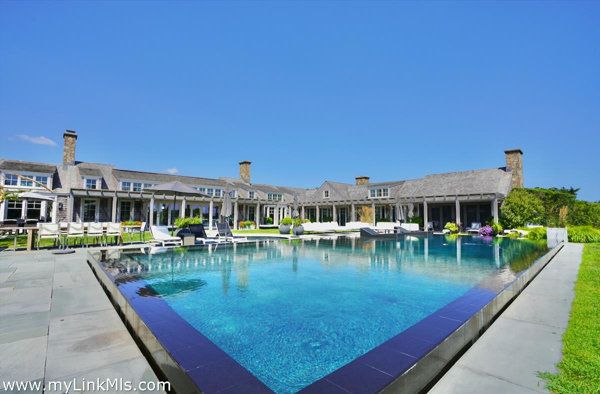 30 Crackatuxet Road Edgartown, MA 02539 - Photo 4 of 45 a view of a swimming pool with chairs