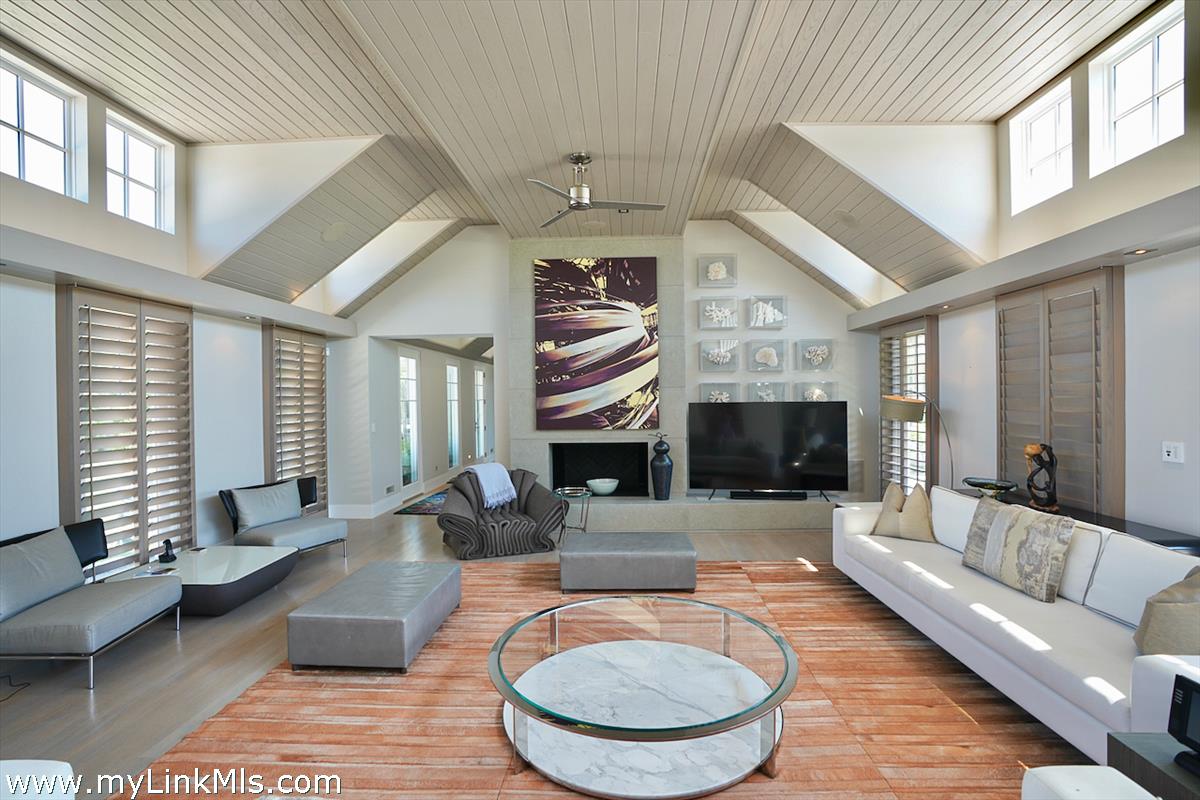 30 Crackatuxet Road Edgartown, MA 02539 - Photo 6 of 45 a living room with furniture a fireplace and a large window