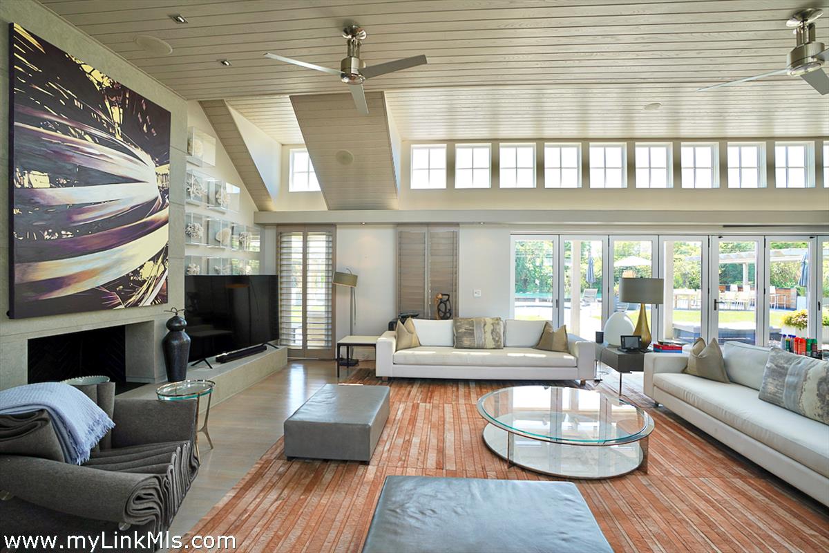 30 Crackatuxet Road Edgartown, MA 02539 - Photo 9 of 45 a living room with fireplace furniture and a large window