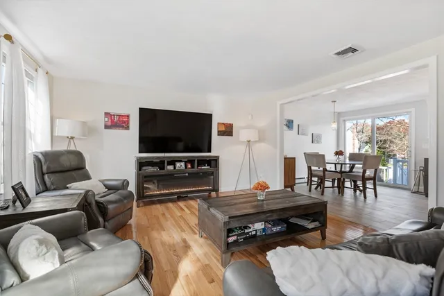 a living room with furniture and kitchen view