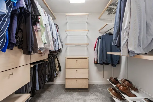 a bathroom with a granite countertop sink and a shower