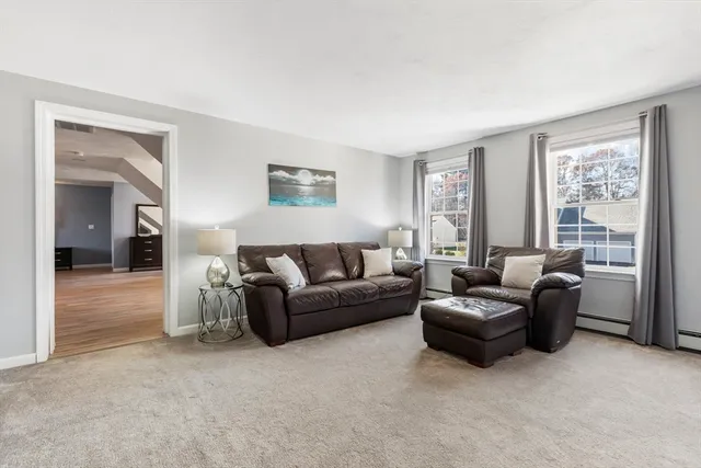 a view of living room with furniture and wooden floor