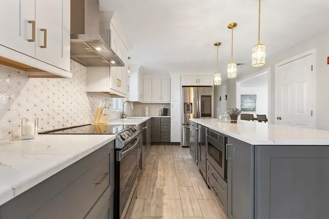 a kitchen with stainless steel appliances a sink stove and refrigerator