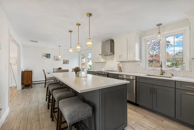 a kitchen with sink and view of living room