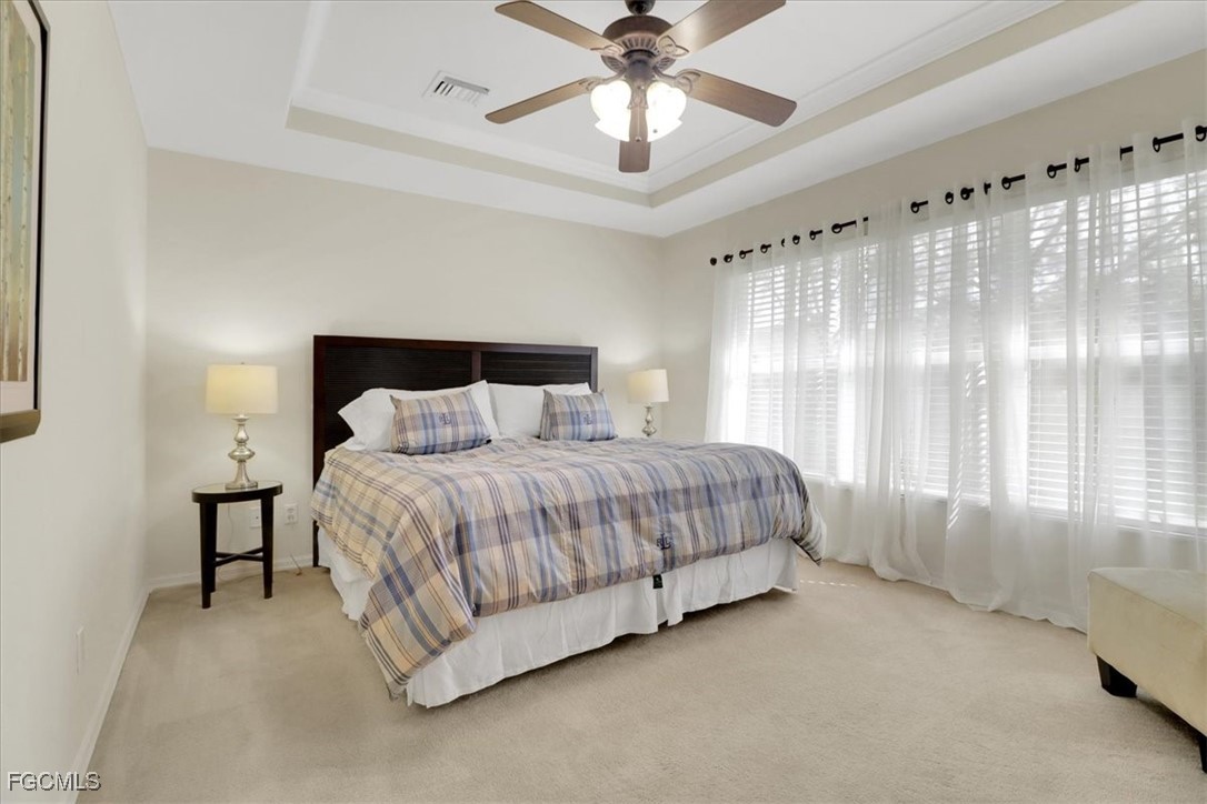 19674 Villa Rosa Loop Estero, FL 33967 - Photo 11 of 33 a spacious bedroom with a bed and a chandelier