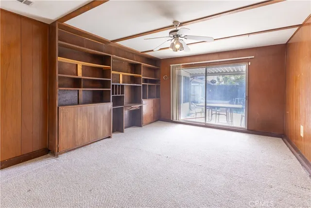 an empty room with windows and cabinet