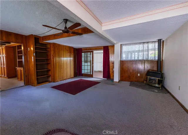 an empty room with furniture and windows