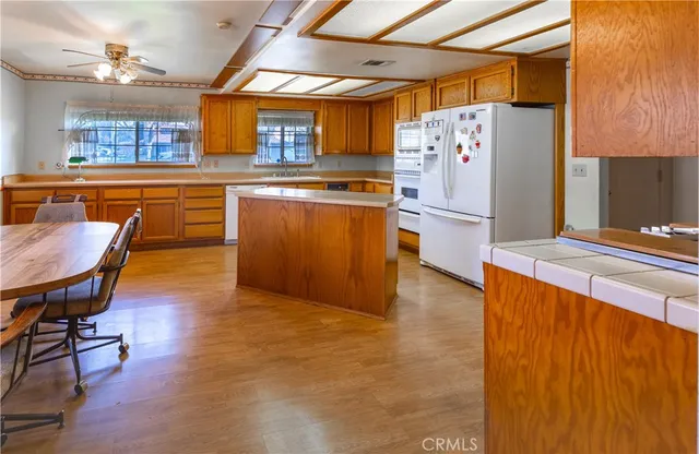 a kitchen with stainless steel appliances a refrigerator and a stove top oven