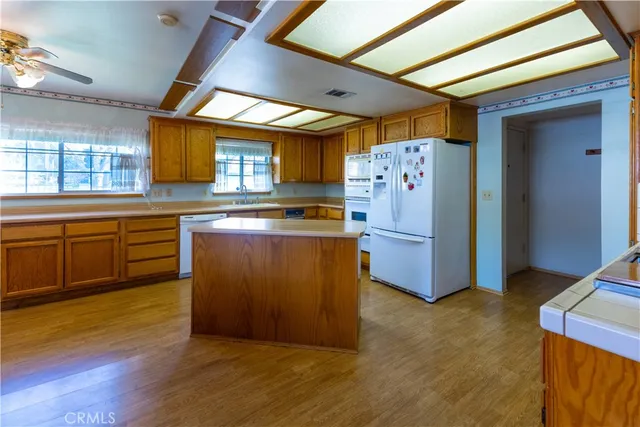 a kitchen with wooden floors and appliances