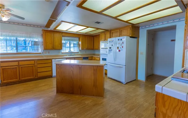 a kitchen with cabinets and wooden floor