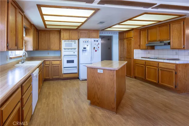 a kitchen with cabinets and wooden floor