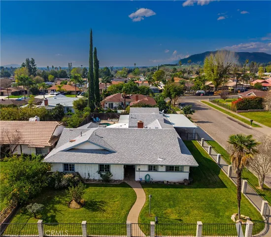 a aerial view of a house with swimming pool garden and outdoor seating