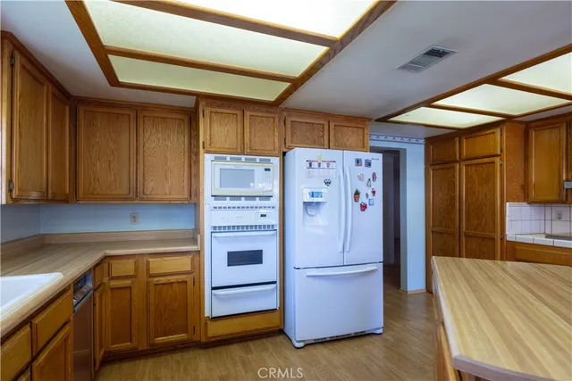 a kitchen with stainless steel appliances a refrigerator and a stove
