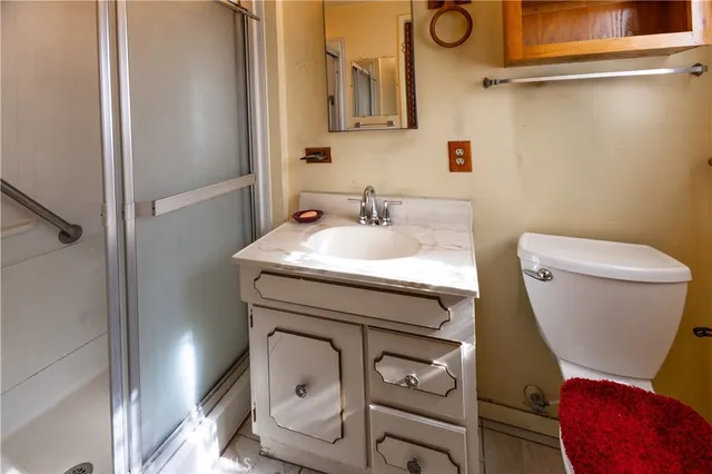 a bathroom with a toilet sink and mirror