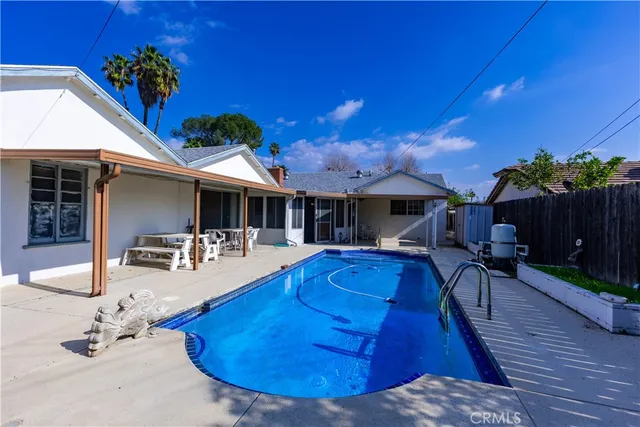 a view of a house with swimming pool and sitting area