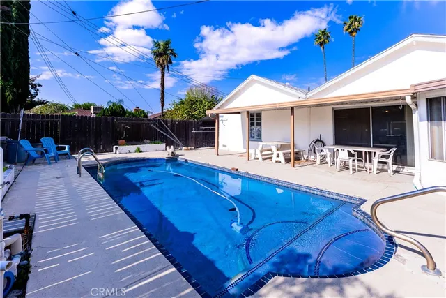 a view of a swimming pool with lounge chairs