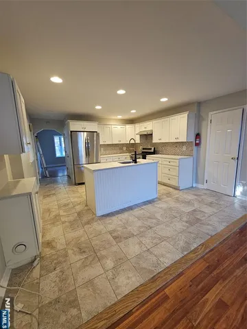 a view of kitchen and hall with wooden floor