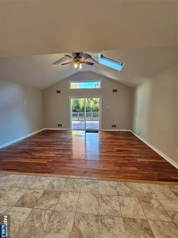 a view of room with window and wooden floor