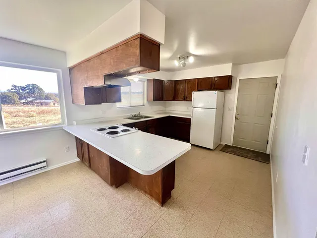 a kitchen with stainless steel appliances a stove a sink and a refrigerator
