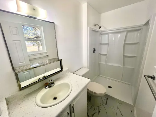 a bathroom with a sink toilet and shower