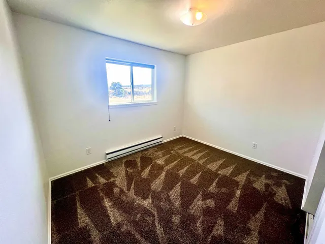 a view of a room with a wooden floor and a window