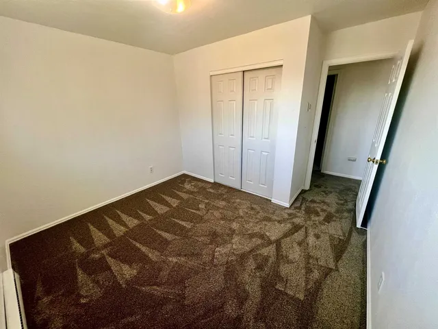 a white toilet sitting next to a bath tub and a shower