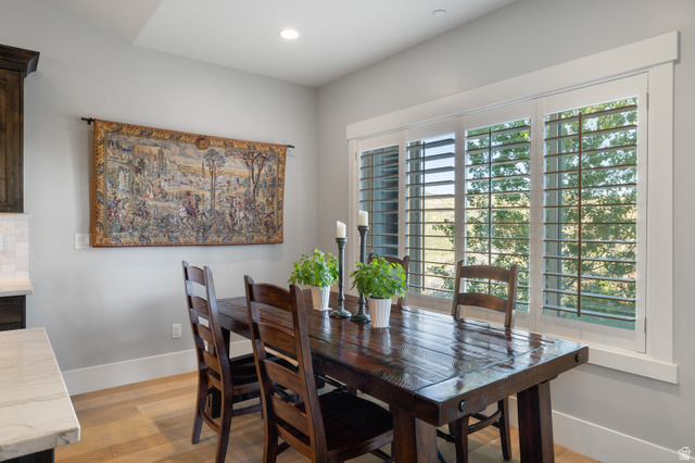 1737 East Viewside Circle Hideout, UT 84036 - Photo 10 of 35 Dining area featuring wood-finish flooring, a large window with plantation shutters, recessed lighting, and a neutral wall color