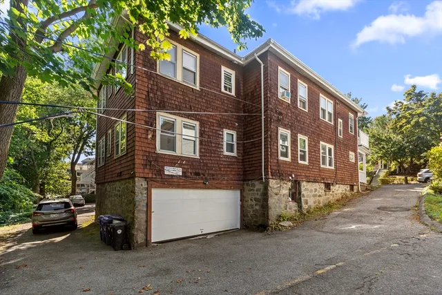 a view of a street with a cars parked in front of it