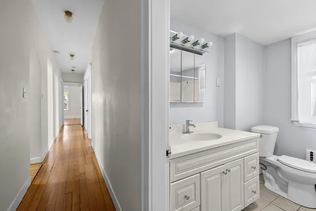 a bathroom with a sink a toilet and a mirror