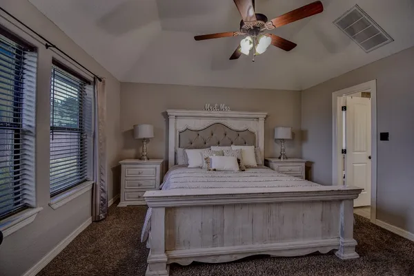 a bedroom with a bed and a chandelier