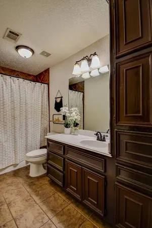 a bathroom with a double vanity sink mirror and toilet