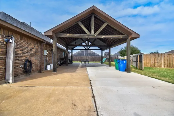 a patio with a table and chairs under an umbrella