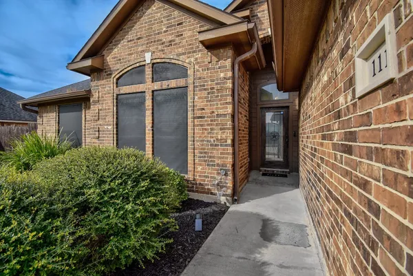 a view of a brick house with many windows