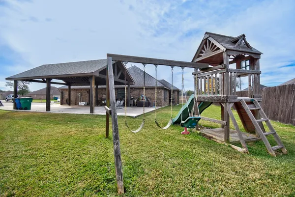 a view of a house with swimming pool and porch