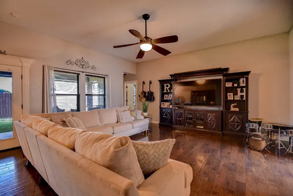 a living room with furniture and a flat screen tv