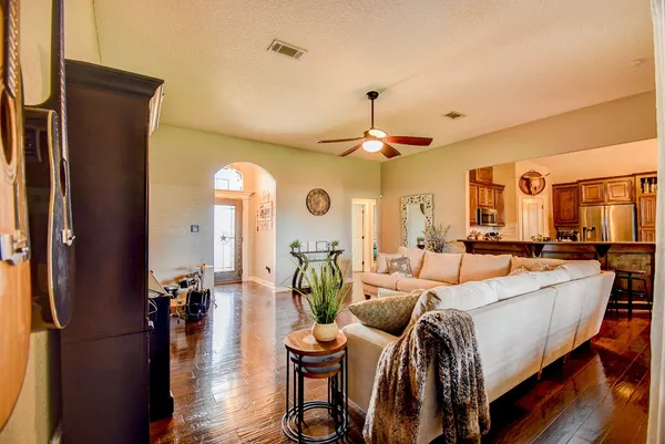 a living room with furniture and a chandelier