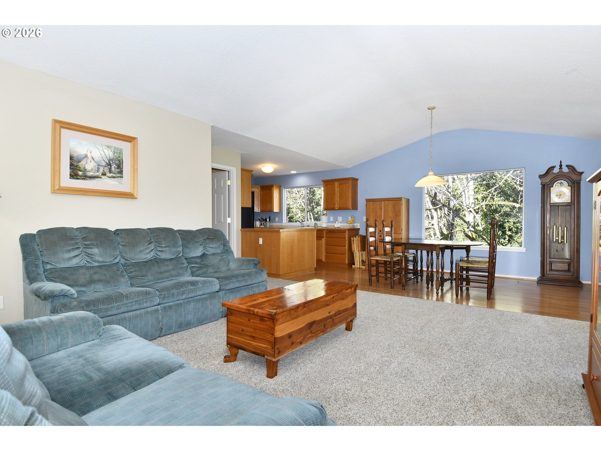 38029 Marcella Court Sandy, OR 97055 - Photo 6 of 29 a living room with furniture and a dining table with floor to ceiling window