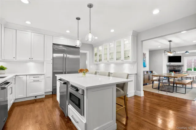 a kitchen with a sink appliances and wooden floor