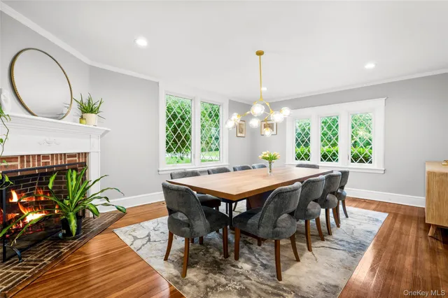 a dining room with furniture a chandelier and wooden floor