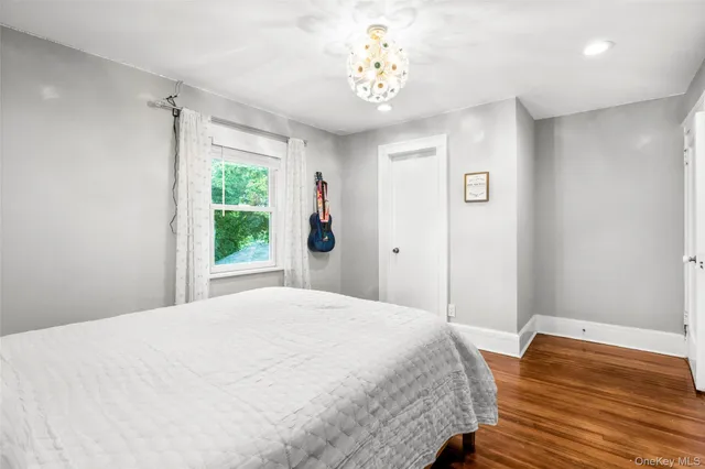 a spacious bedroom with a bed and a window