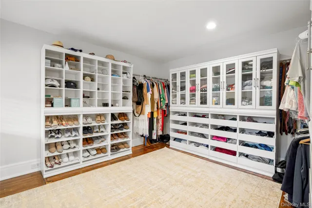 a view of walk in closet with clothes and shoes