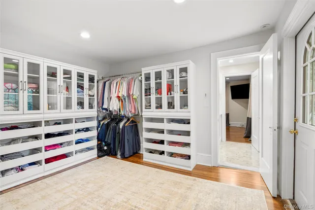 a view of walk in closet with clothes and shoes