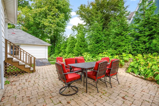 a backyard of a house with table and chairs